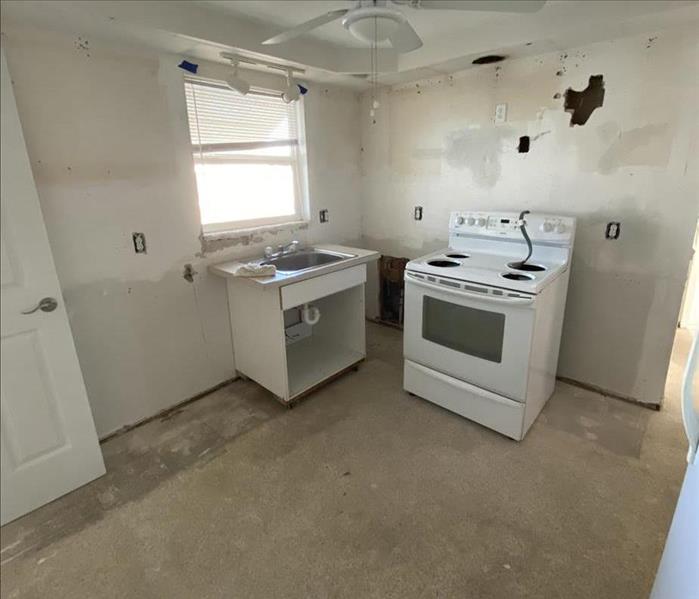empty kitchen, no cabinets, just oven